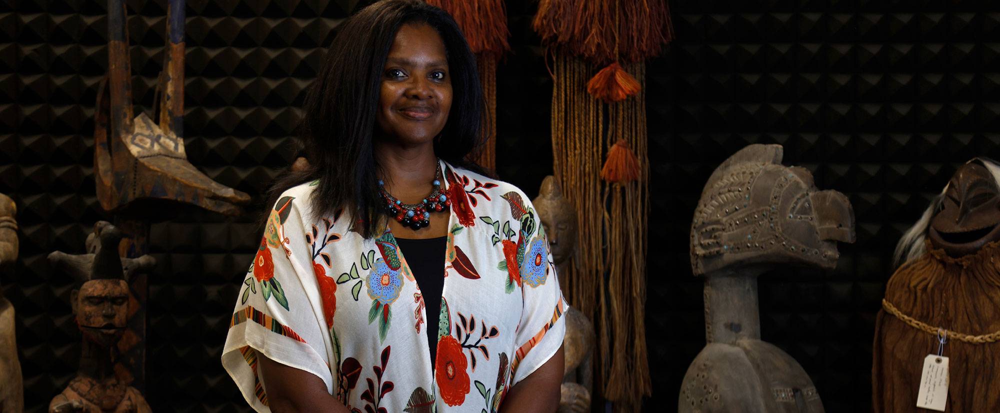 Dr. Denise Rogers Dr. Denise Rogers stands in front of pieces in the World Art Collection