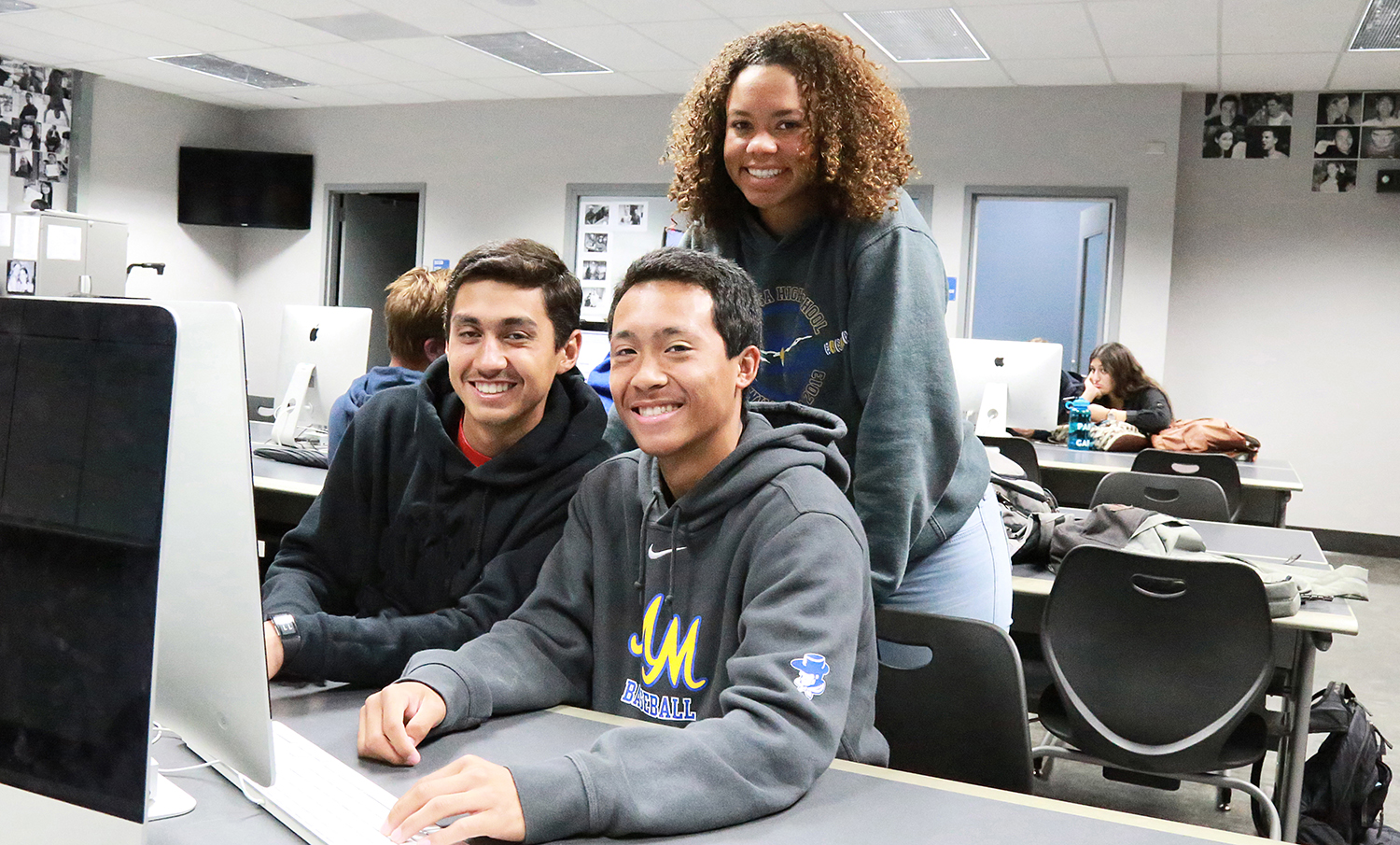 Three dual enrollment students sit at a computer
