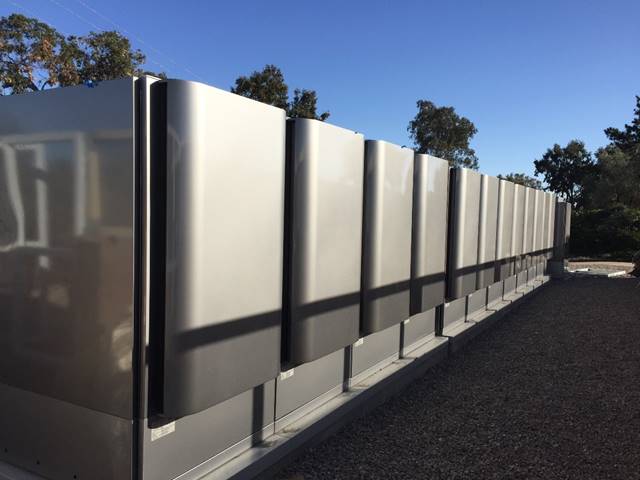 About 12 gray fuel cells on a rooftop