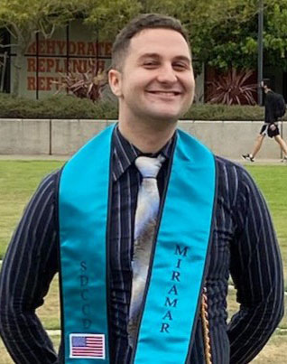 Michael Raska wears a teal Miramar graduation sash