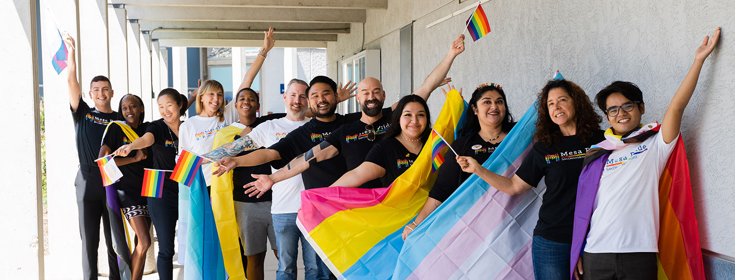 Members of Mesa College’s Pride Center welcome committee show their colorful spirit with pride flags