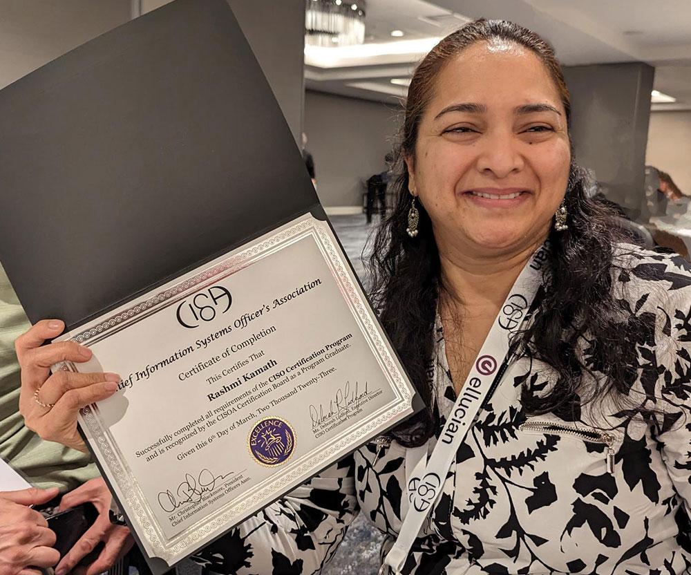 Rashmi Kamath holds up her certificate of completion