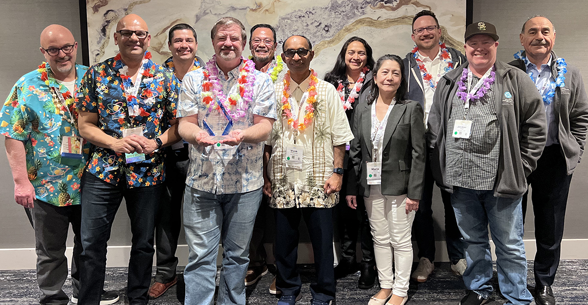 10 members of the IT team pose for a photo at the award banquet