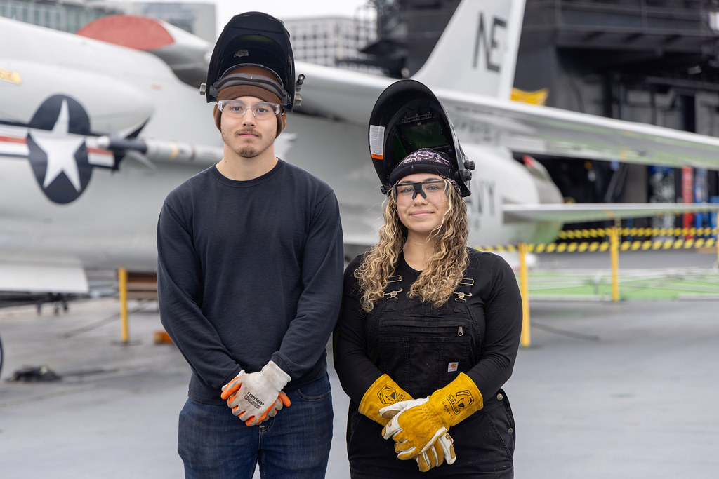 Student welders Mark Silva, and Ariana Espinoza on board the USS Midway.