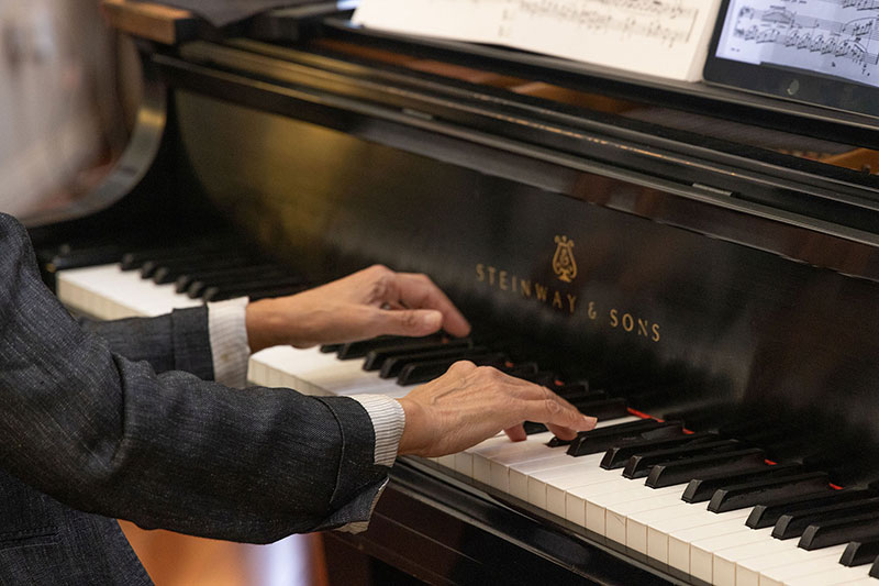 A close up of Helena Wei's hands playing the piano