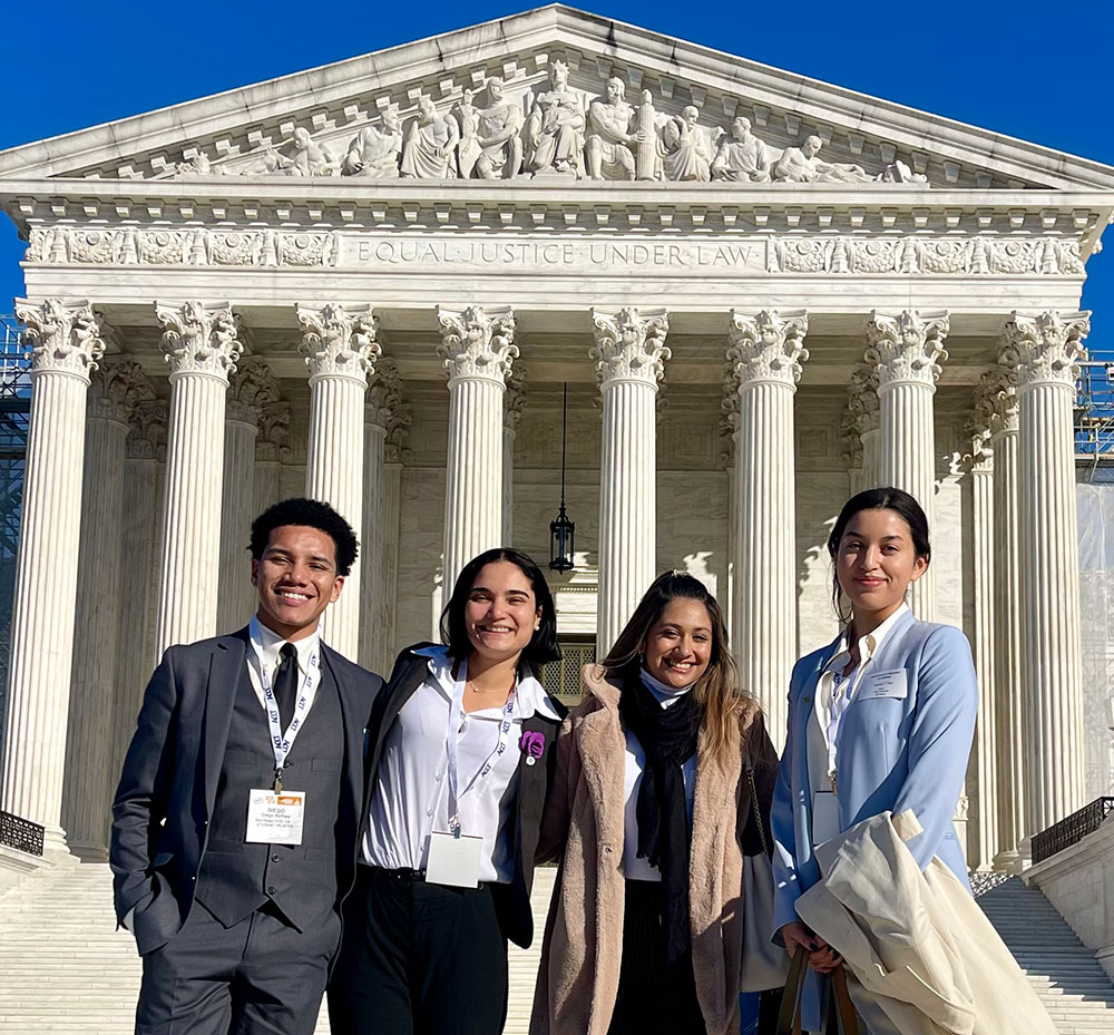 The four student trustees stand in front of the Supreme Court building in Washington D C