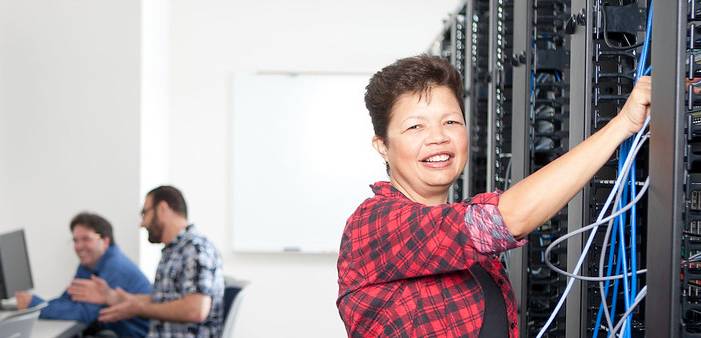 A student looks over wires for an internet server