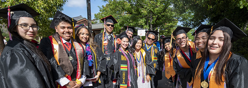 A group a students wearing graduation caps and gowns