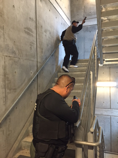 Two officers go up stairs with guns during a training exercise