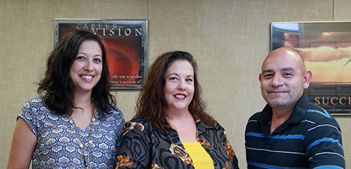 Three human resources employees at a counter