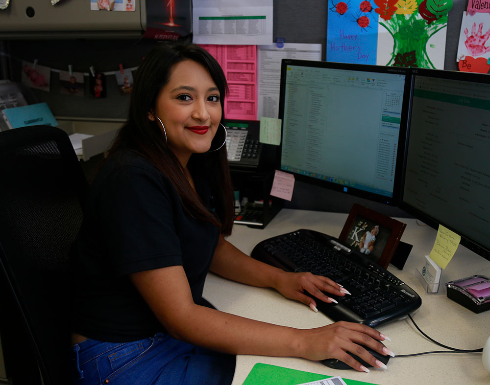An employee works at her desk