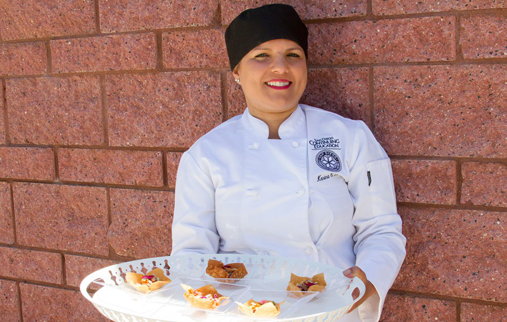 a cooking student serves hors d'oeuvres