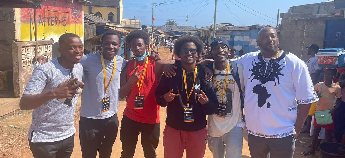 Students pose for a group photo on a road in Ghana