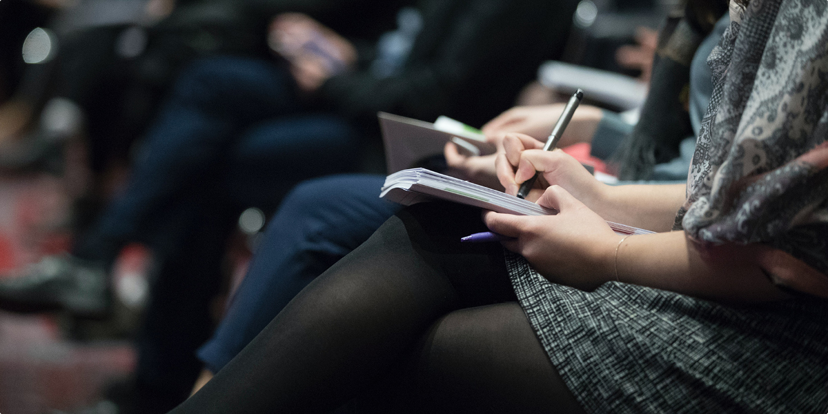 A close up of a student writing in a notebook