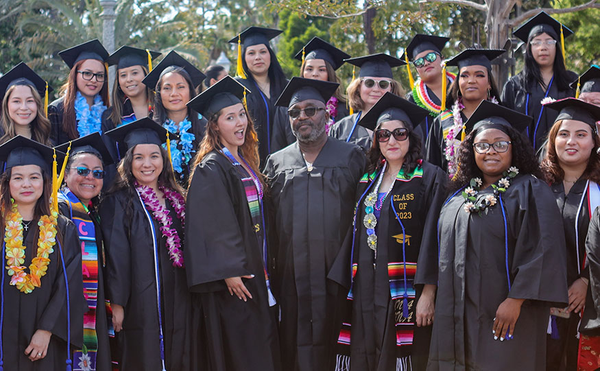 A group of students in black graduation caps and gowns at San Diego College of Continuing Education's 2023 Commencement