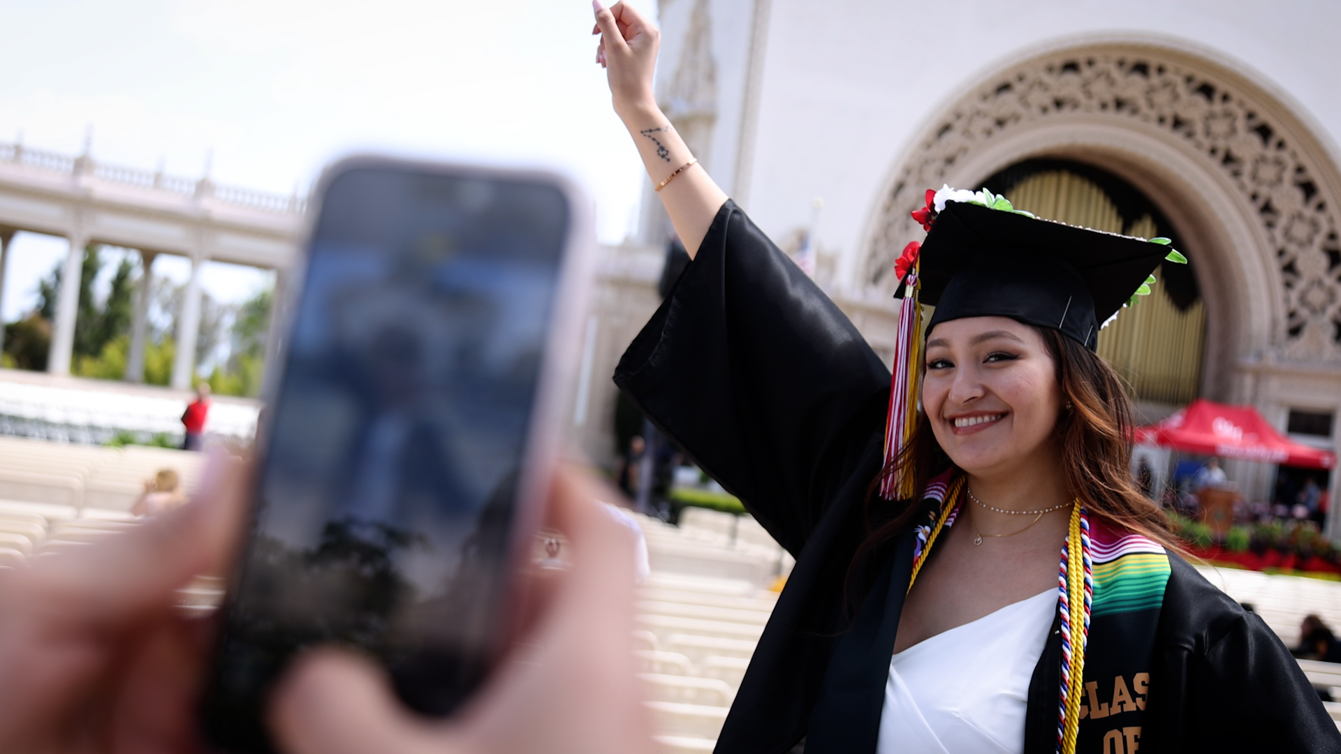 A student in a cap and gown at the Organ Pavillion
