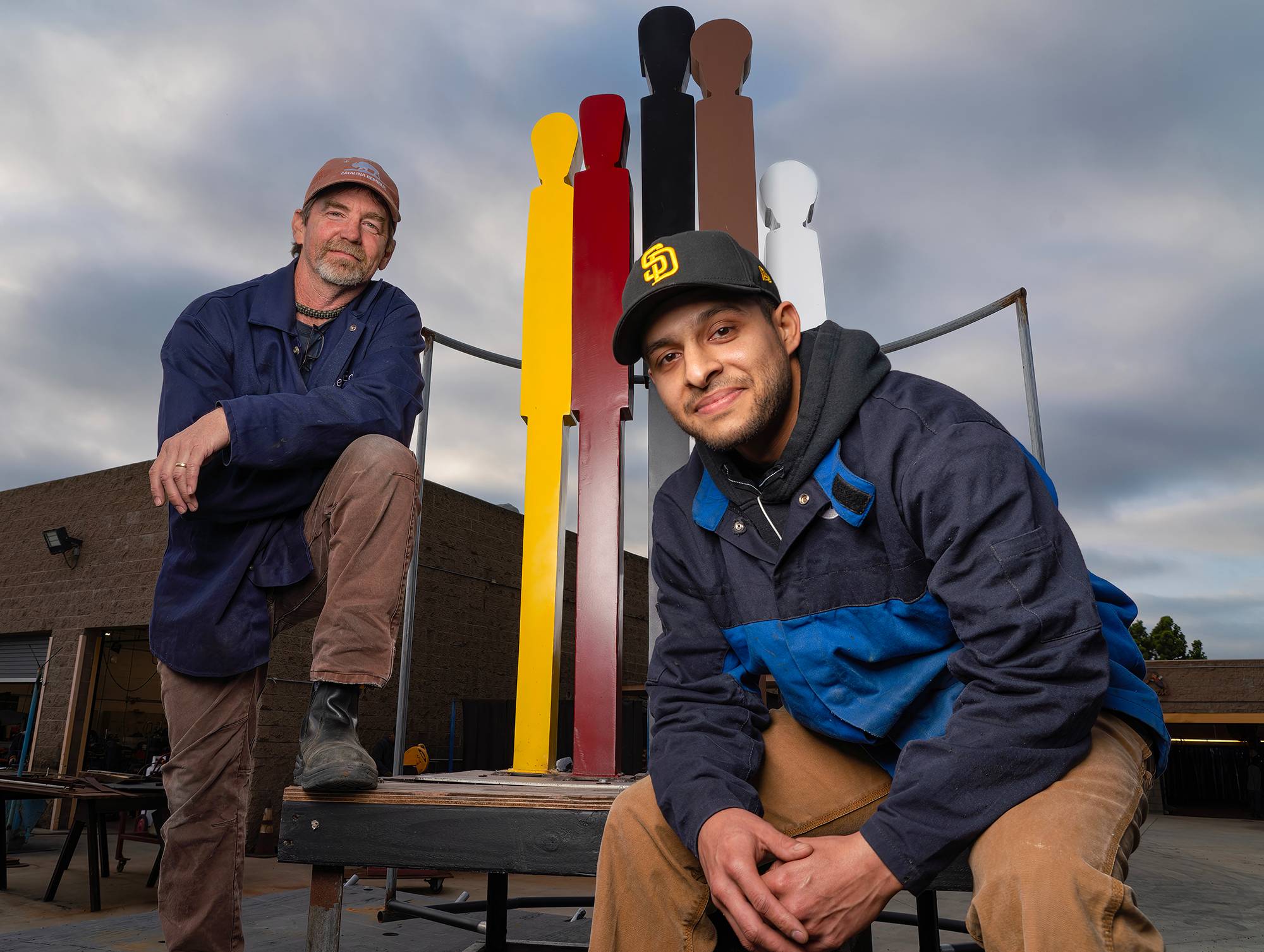 Nathan Torres and welding professor Mike Bradbury with a replica that students created of The Black Family statue.