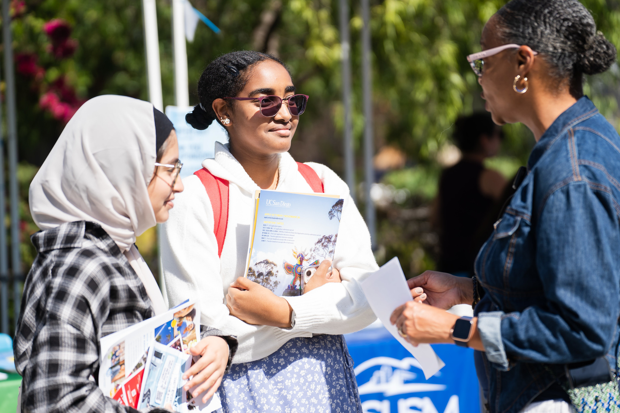 Two students talk with Mesa College President Ashanti Hands at a transfer event