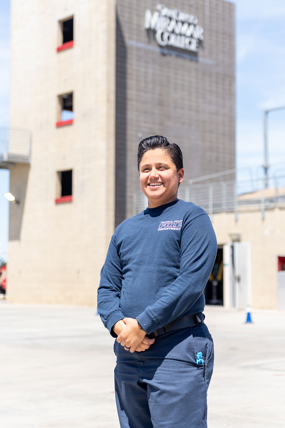 Erika Tello stands in front of the tower that Miramar uses for fire training.