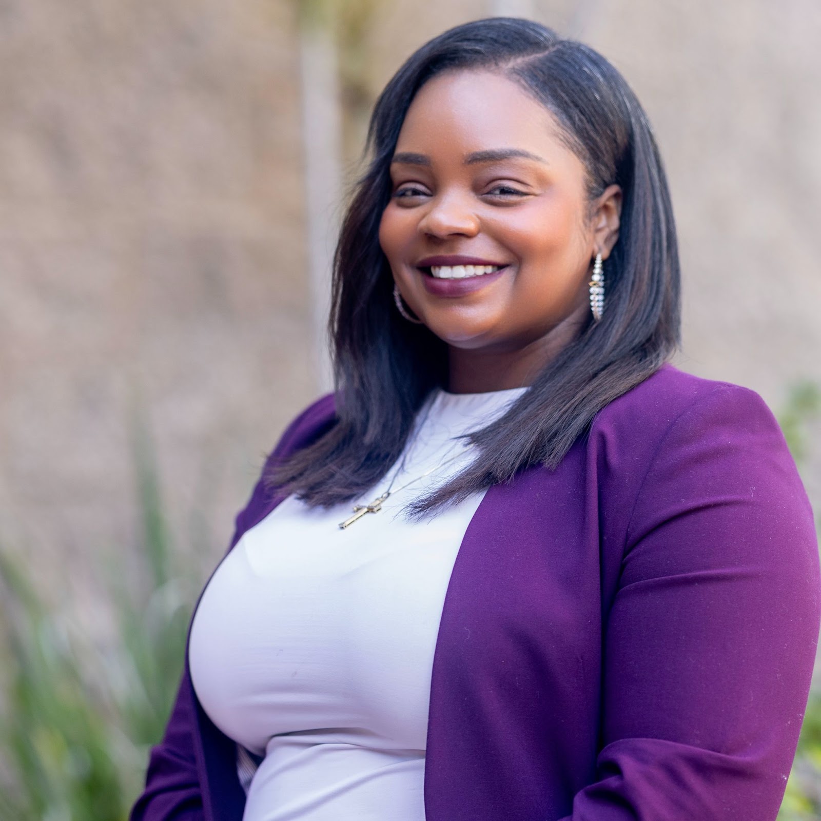 Shakerra Carter wearing a white top and purple cardigan