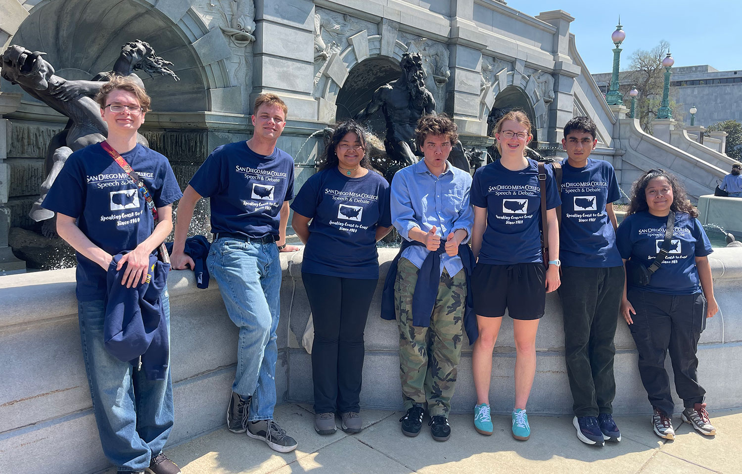 Seven students in front of statues in Washington, D.C.