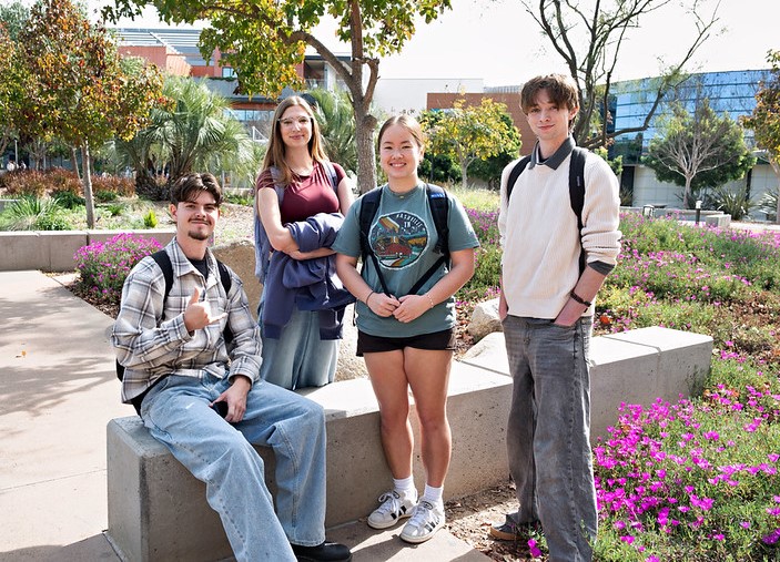Four students outside among trees and flowers at Miramar College