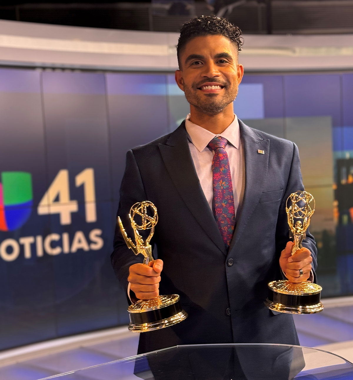 Jesus Lopez shows off a pair of Emmy statues