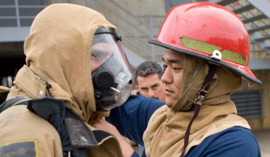 trainees put on fire protection gear