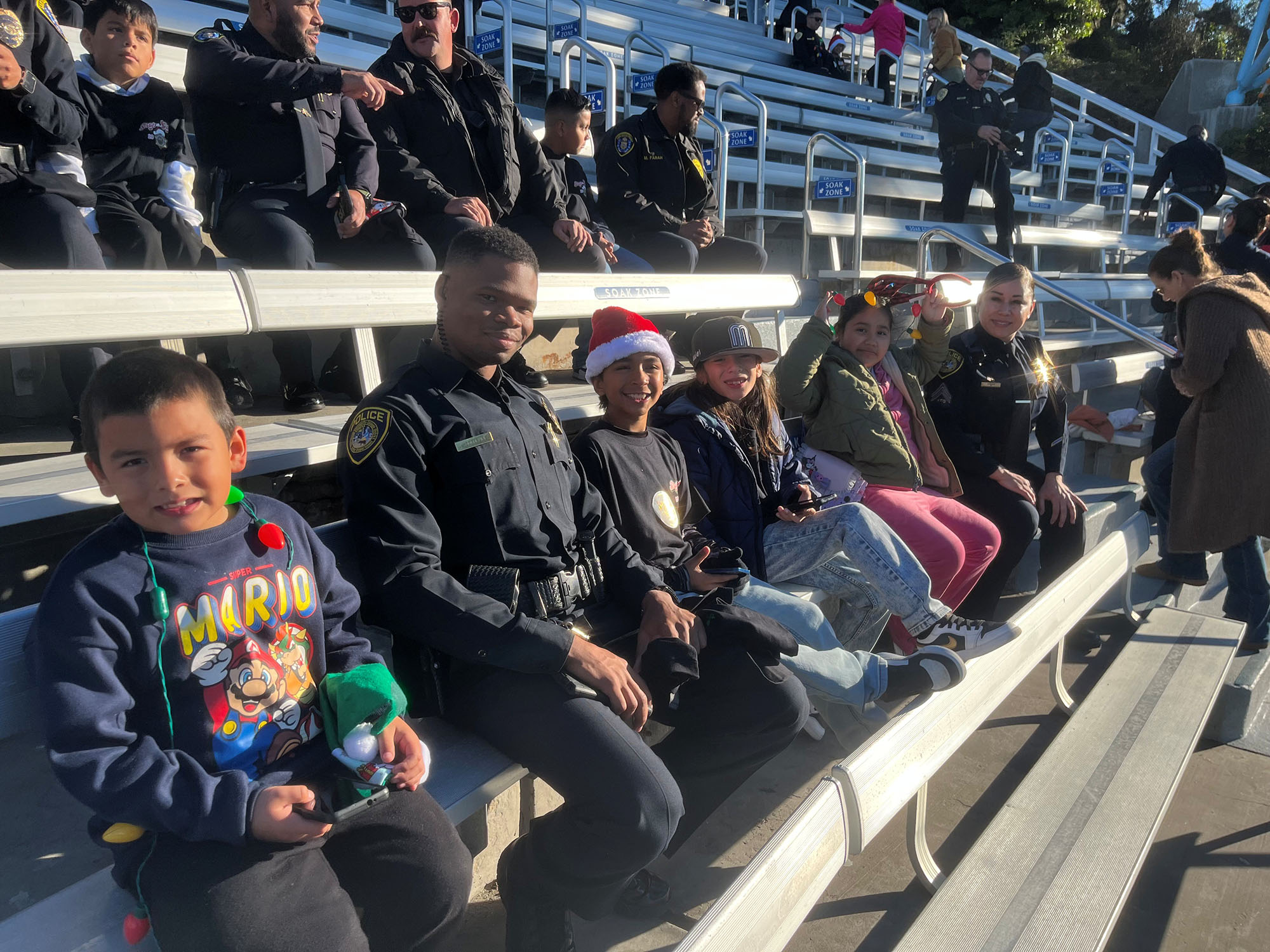 College Police and children in seats to watch a show at SeaWorld.