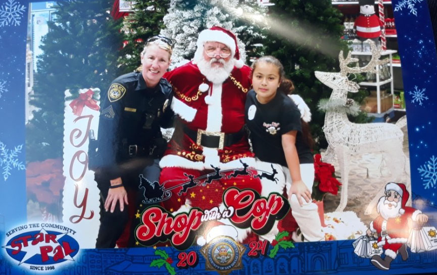 A police officer and a child with Santa.