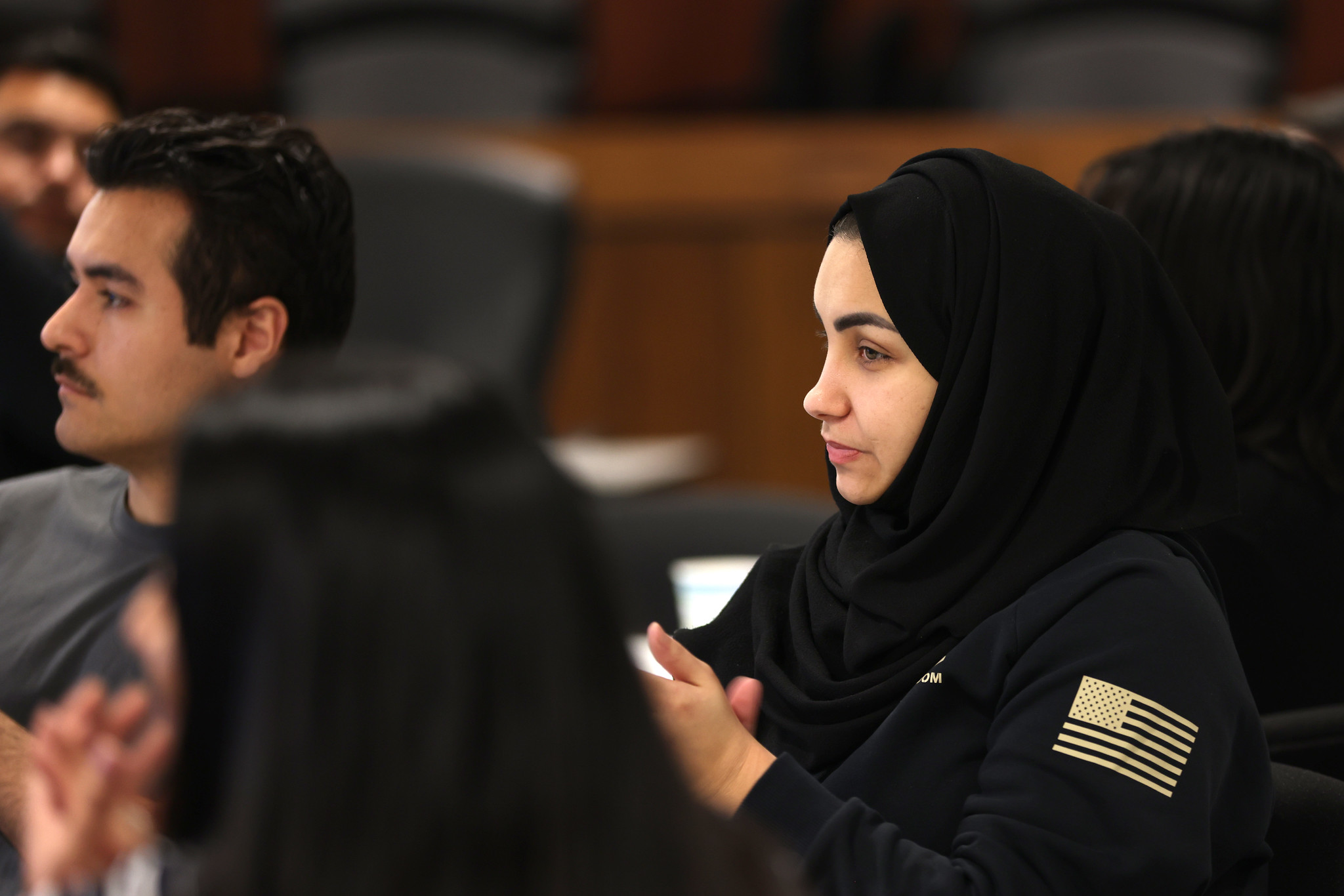 People in the audience applaud.