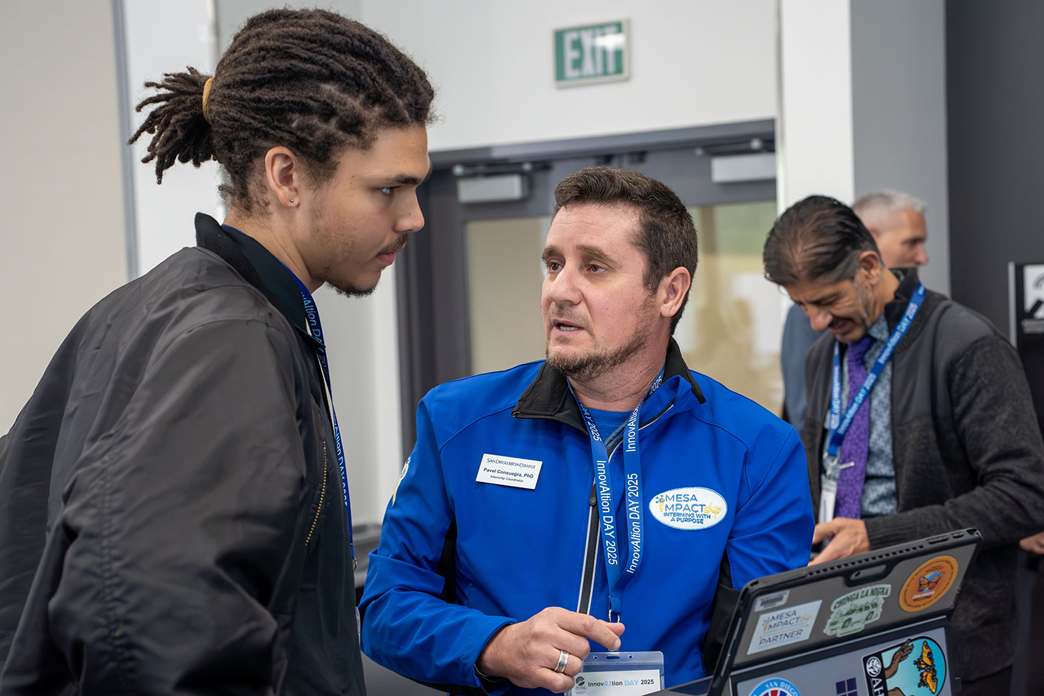 
Two attendees looking at a laptop.
