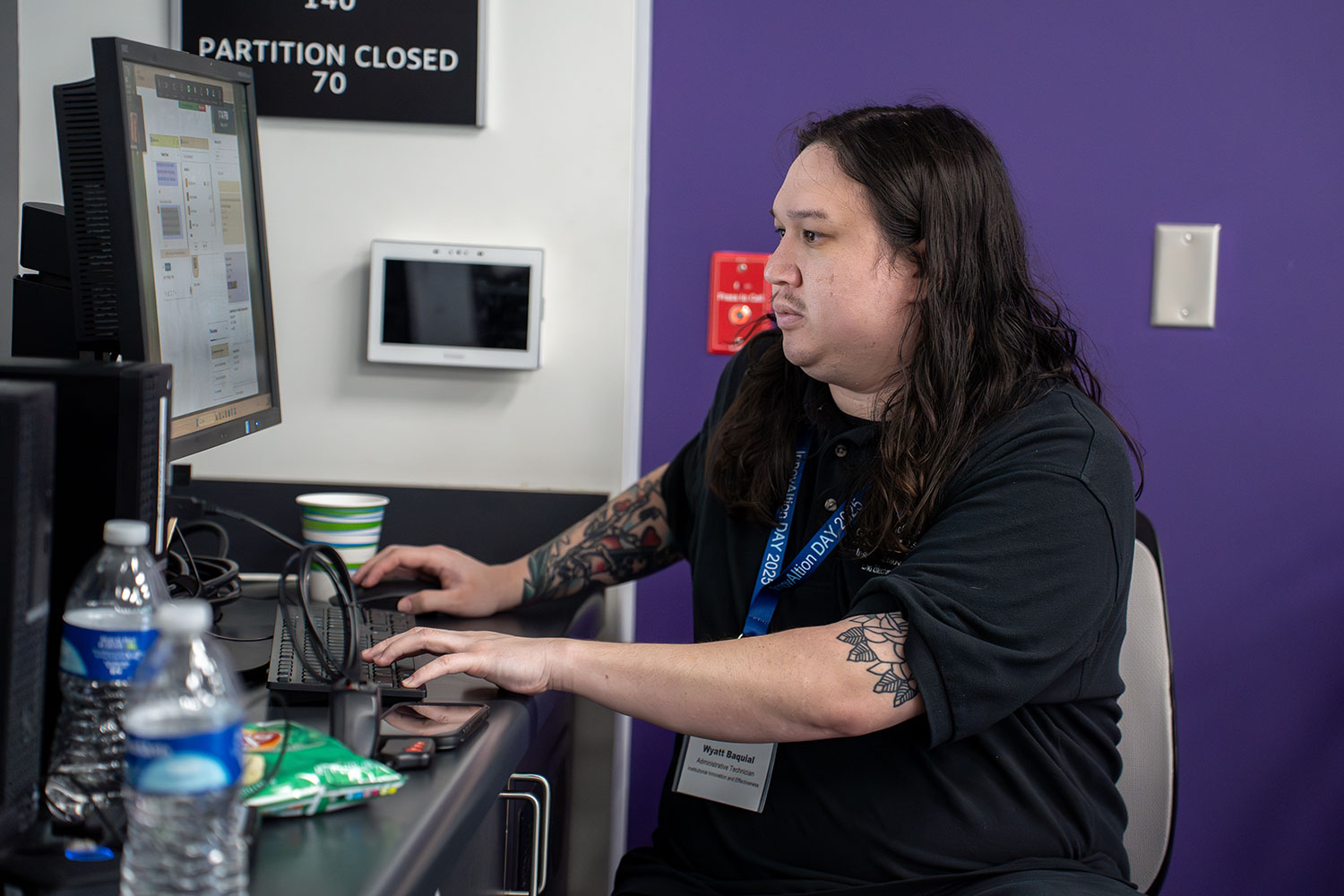 
Institutional Innovation and Effectiveness employee Wyatt Basquiat working at a desktop computer.
