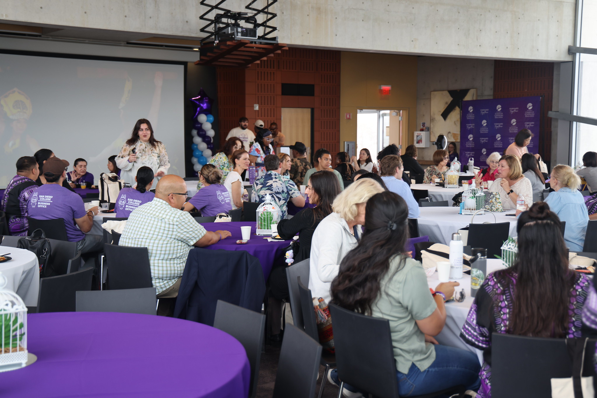 
Employees gather at tables for lunch.
