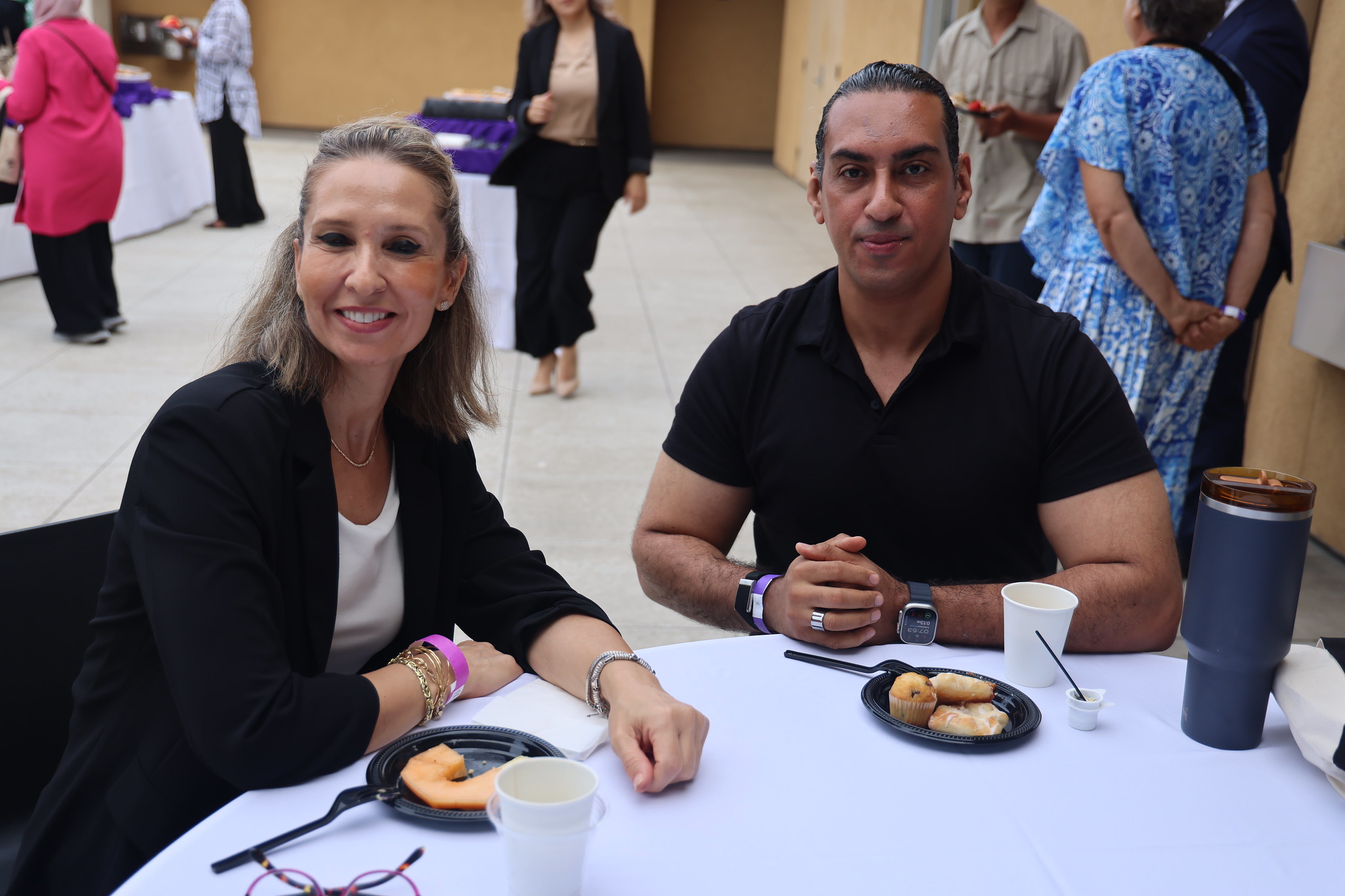 
Two employees at a table for the lunch served after convocation
