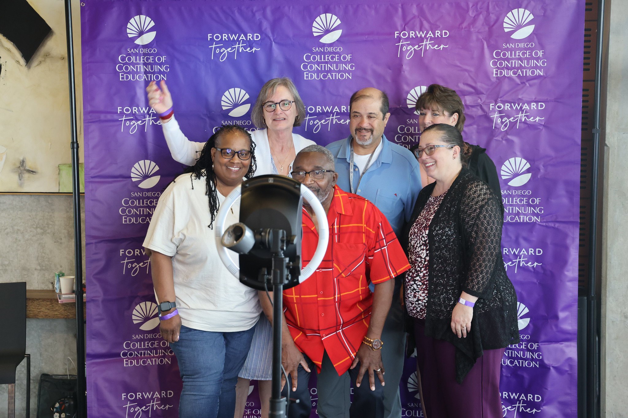 
Six employes take a selfie in the photo booth.
