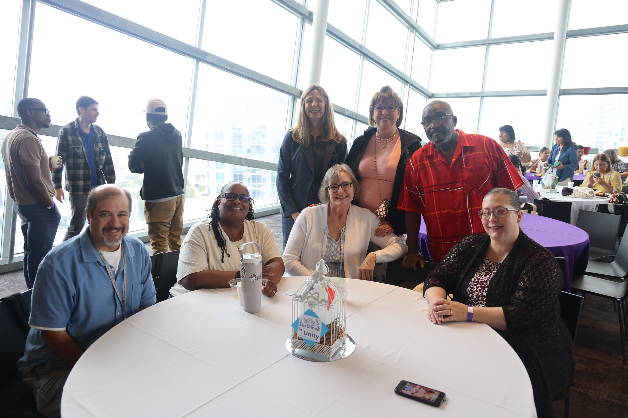 
Seven people gather around a table at lunch.
