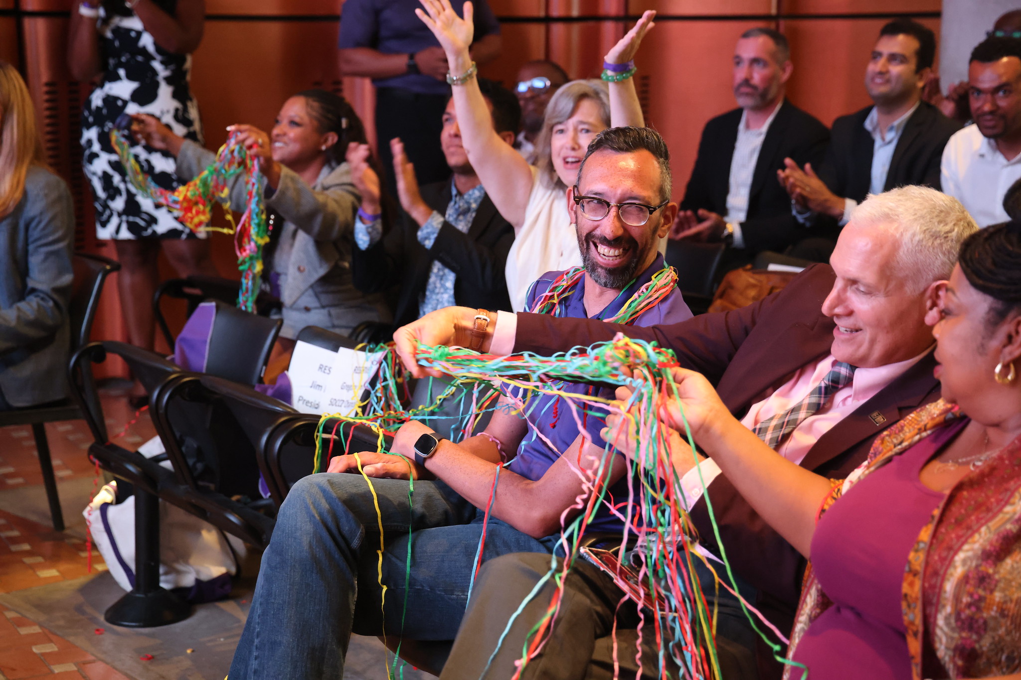 
Neil Kovrig and Richard Weinroth in the audience and covered in confetti streamers.
