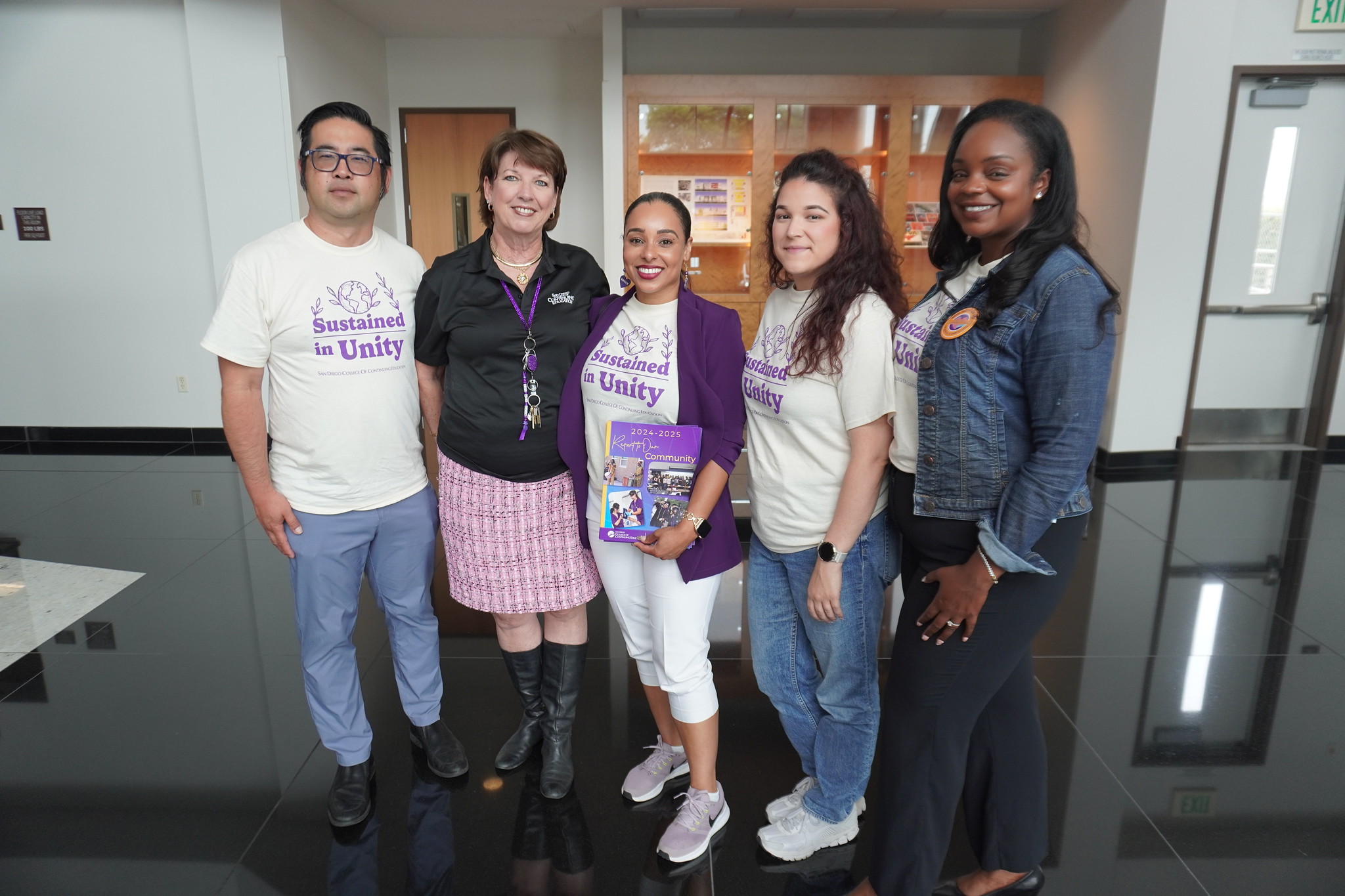
President Tina King with four employees at a campus.
