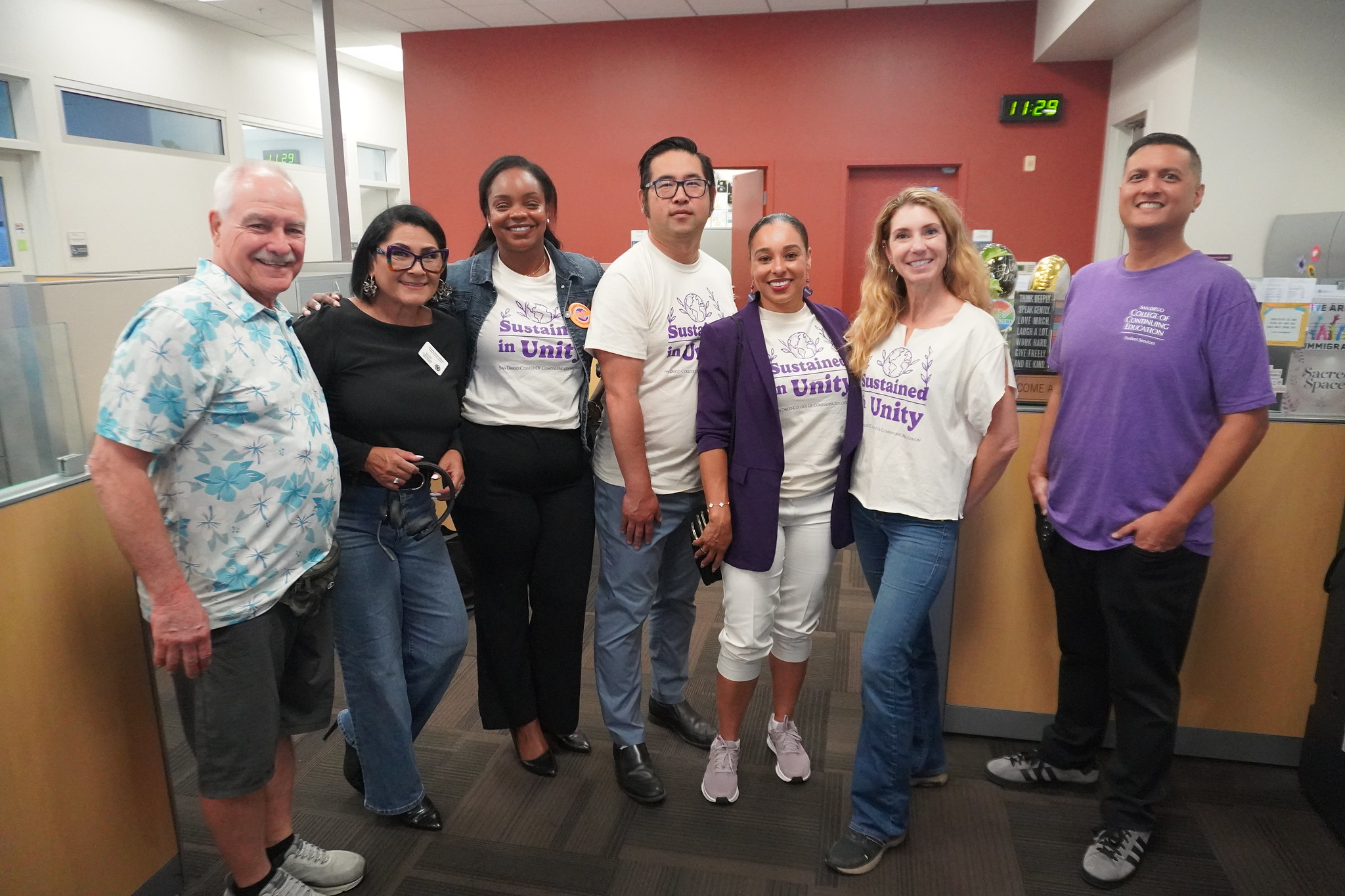 
President Tina King with seven employees at a campus.

