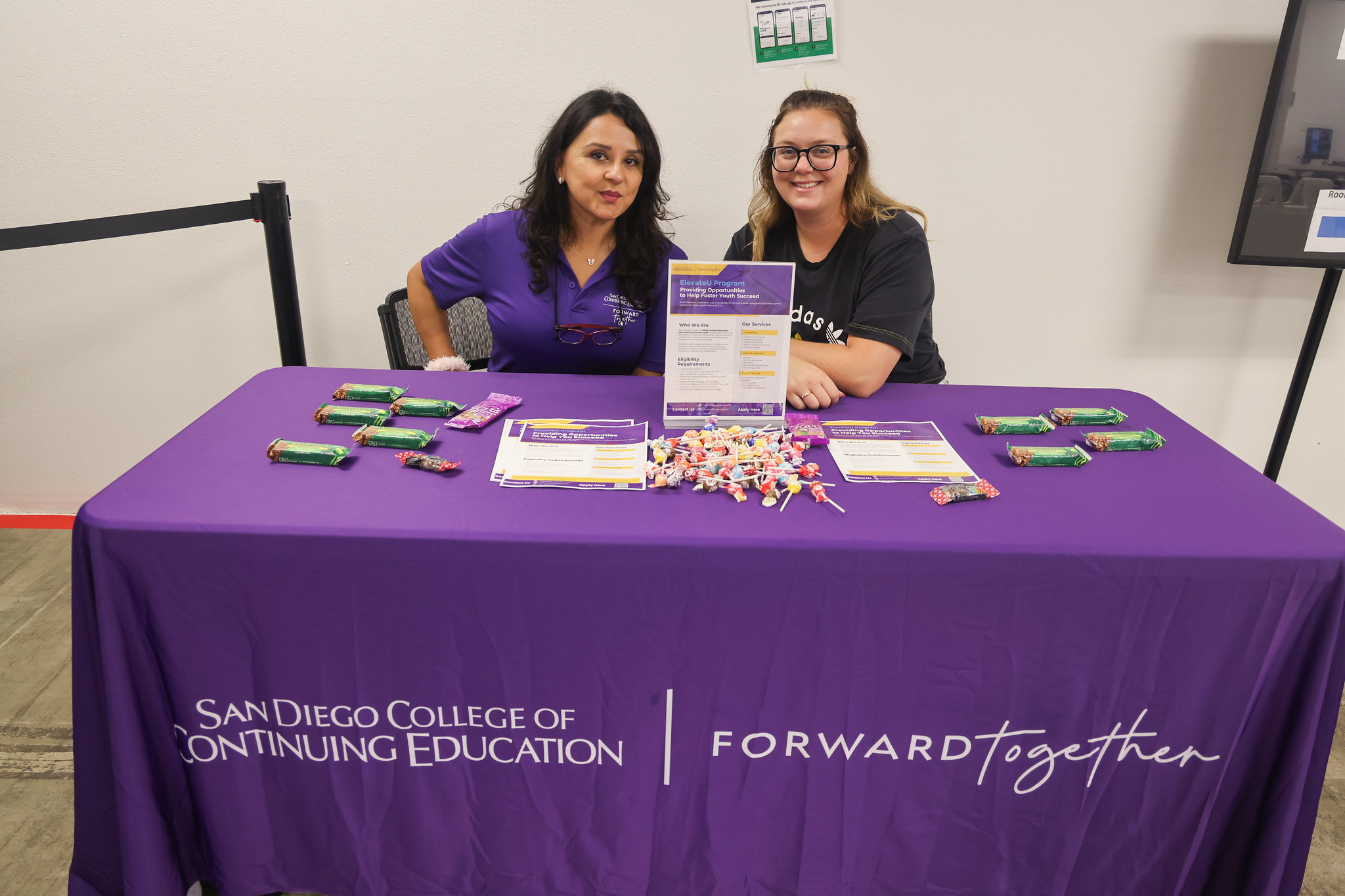 
Two ladies working at a welcome table. 
