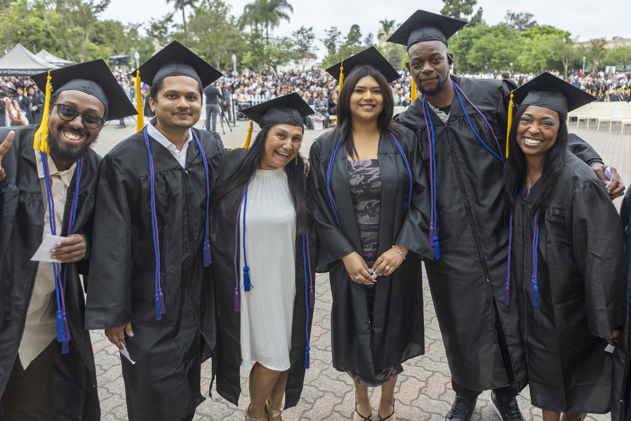 
Six graduates take a group photo.
