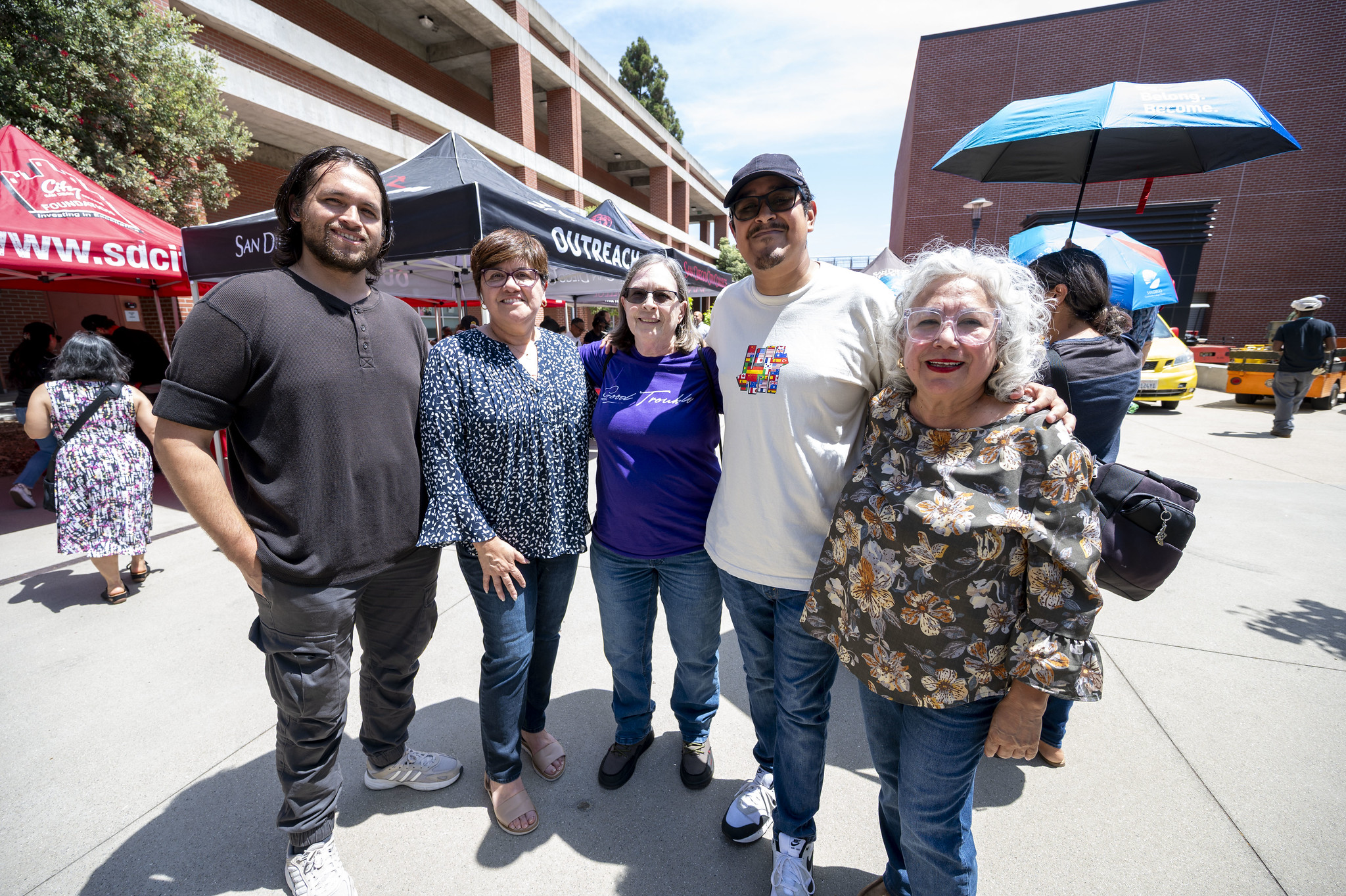 
Five employees pose for a group photo.
