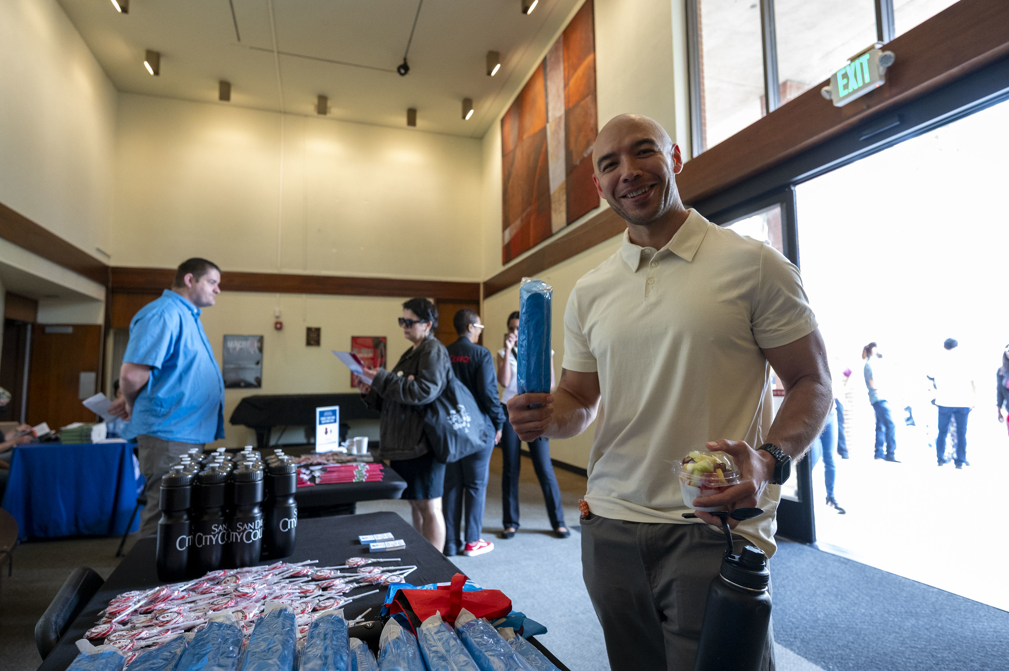 
An employee receives on of the district umbrellas that were handed out at convocation.
