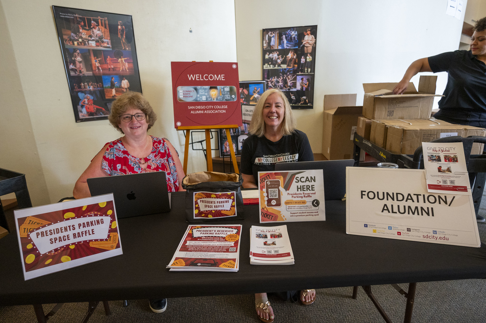 
Two ladies at a table managing the raffle to park in the president's parking space.
