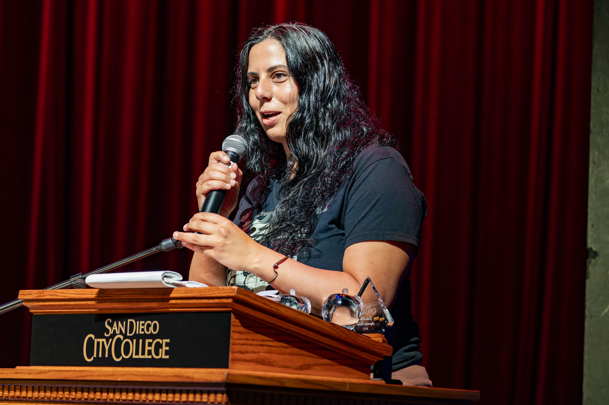 
An employee at a podium speaks at convocation.
