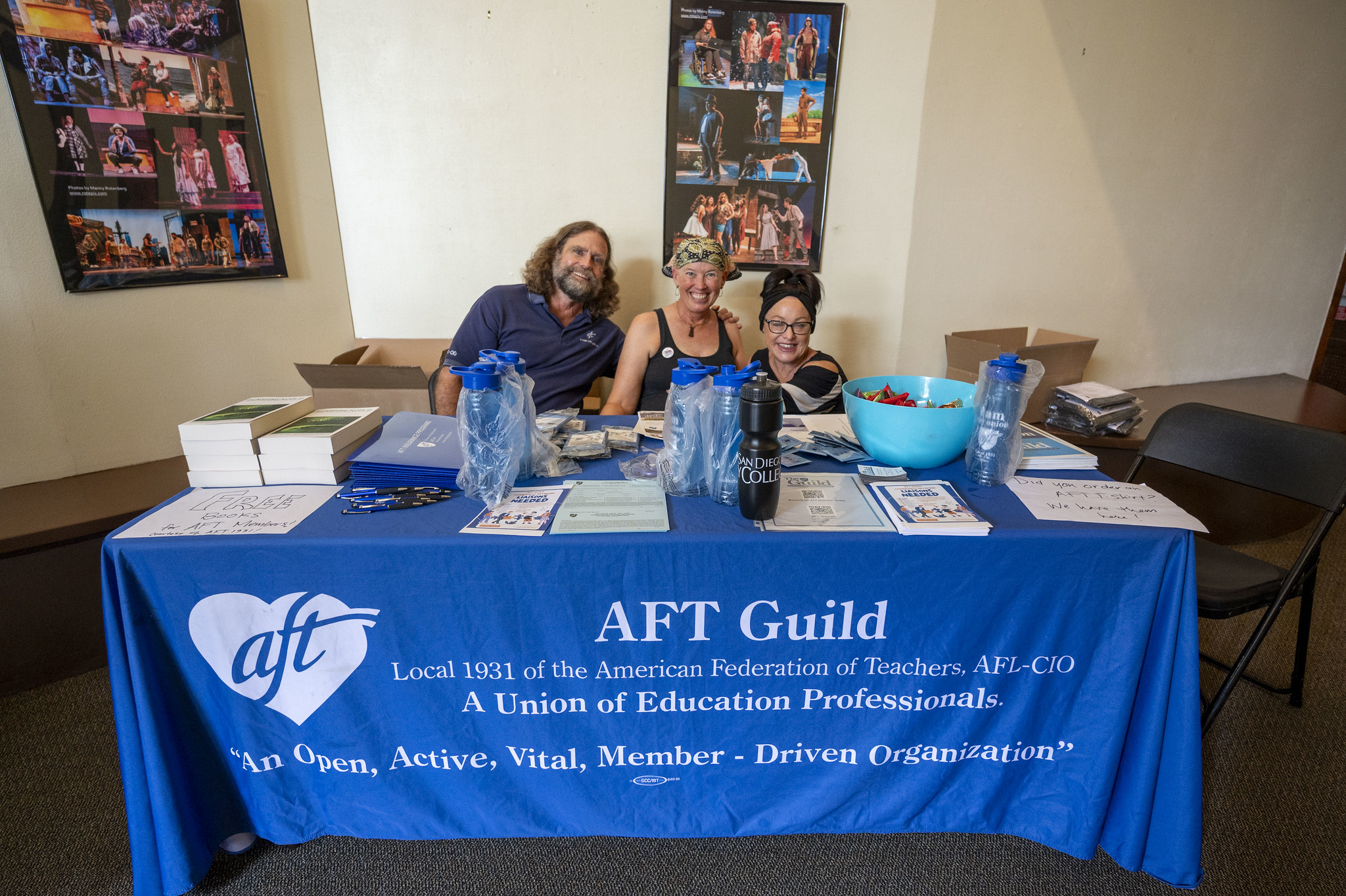 
Three people sitting at the AFT Guild information table
