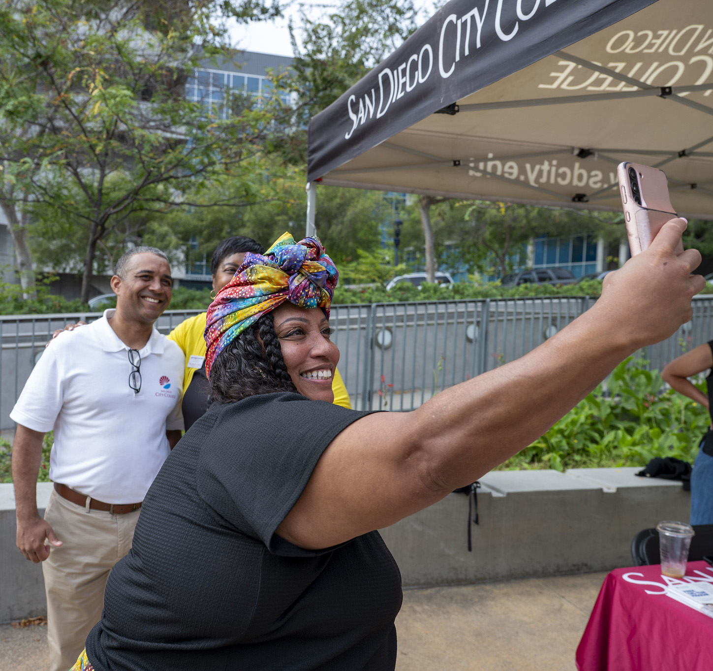 
City College President Ricky Shabazz takes a selfie with two employees during the first week of fall 2025.
