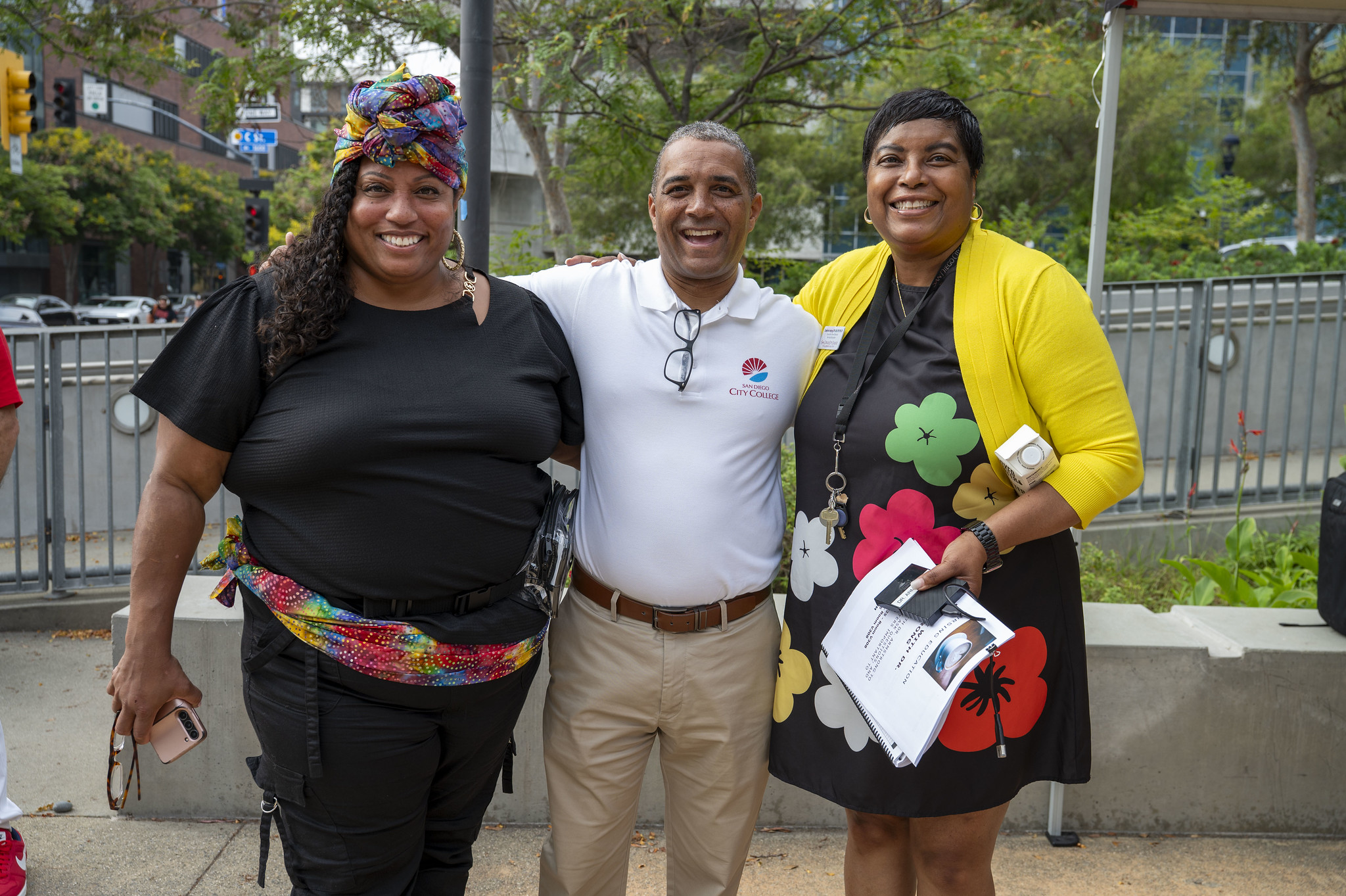 
City College President Ricky Shabazz with two employees during the first week of the fall semester.
