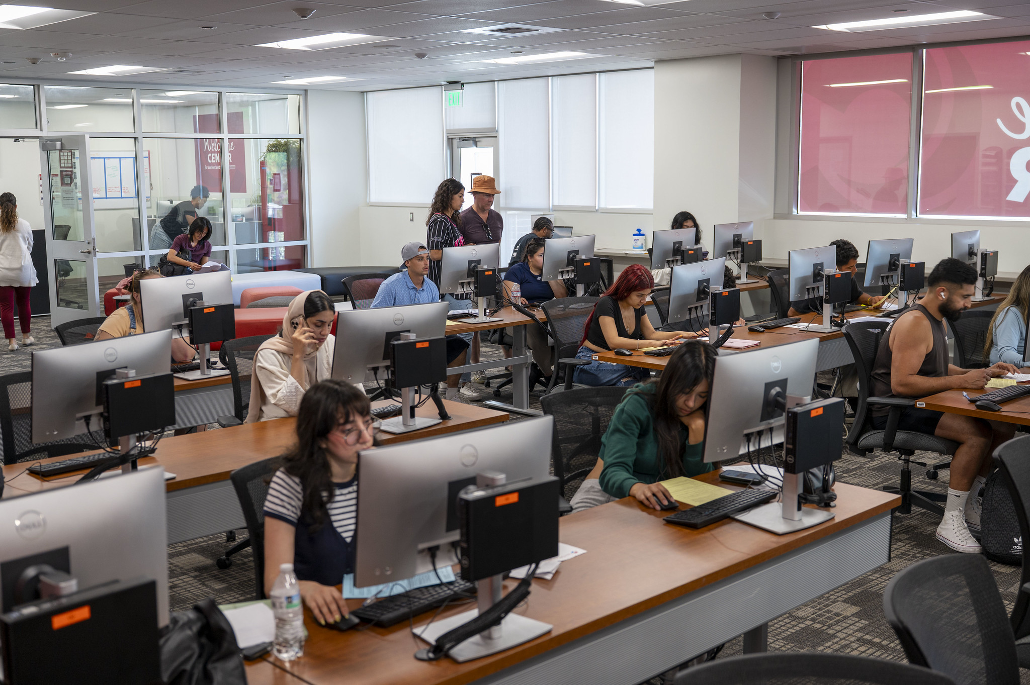 
A classroom of people sitting at computer stations.

